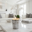 Bougie luxe Sahara allumée sur table marbre, décoration salon blanc et lumineux
