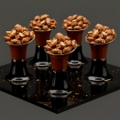 Cinq mises en bouche Alizée porcelaine marron, amandes caramélisées sur plateau noir